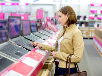 Woman in Retail Computer Store looking at laptops