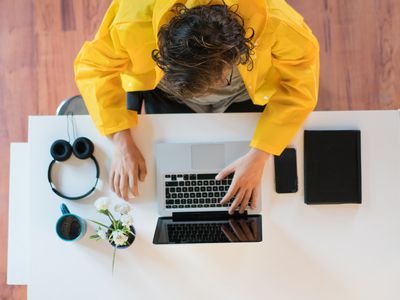 Viewing someone using their MacBook from the top.