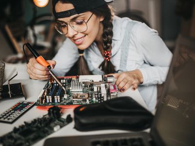 Woman working on a computer motherboard.